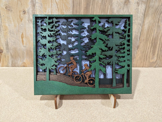 Two Mountain Bikers in the woods scene. Layered wood sign Medium Size.